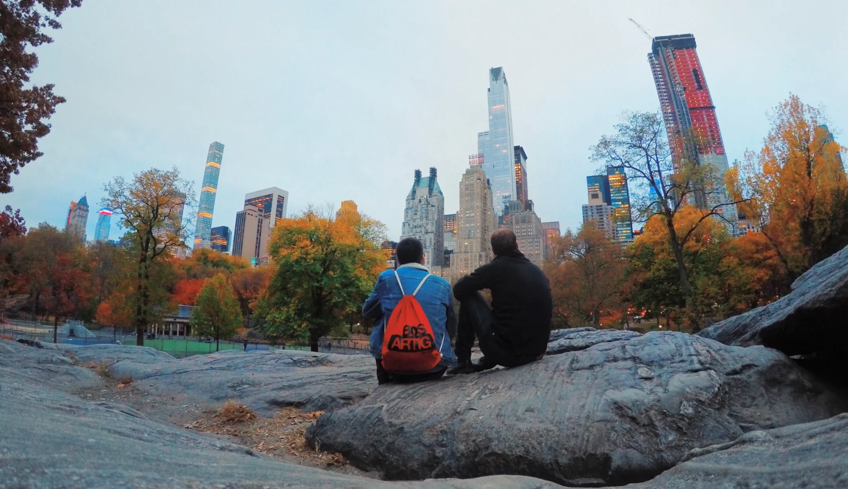 Two people overlooking the New York skyline from Central Park